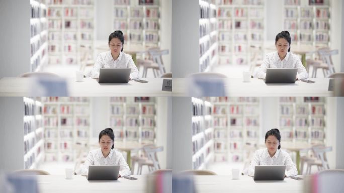 女性在图书使用笔记本电脑工作