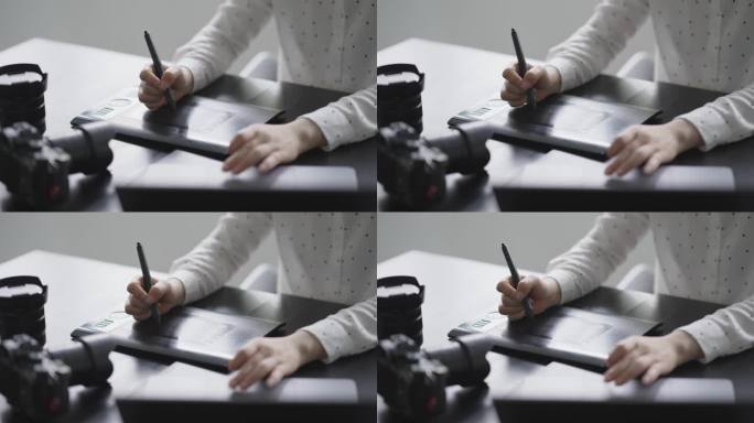 女摄影师使用数位板在笔记本电脑处理照片