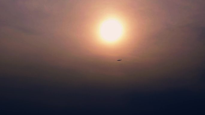 落日下午无人机航拍夕阳飞机经过大楼