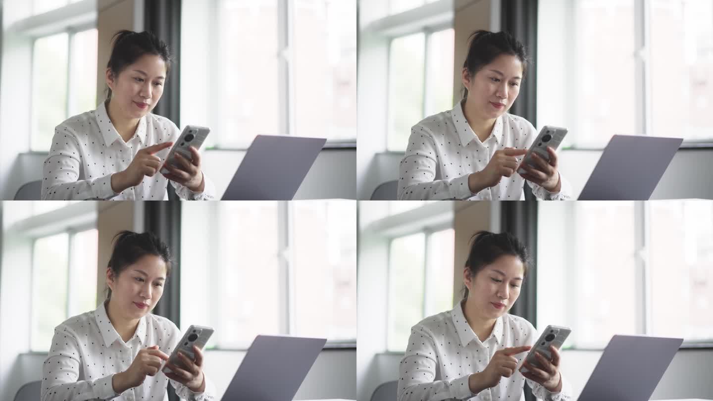 中年女性在办公室使用手机