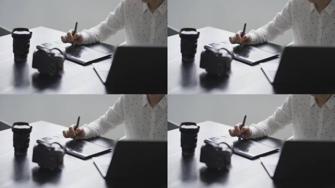 女摄影师使用数位板在笔记本电脑处理照片
