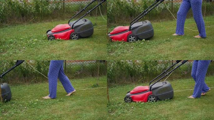 用电动割草机修剪草坪。