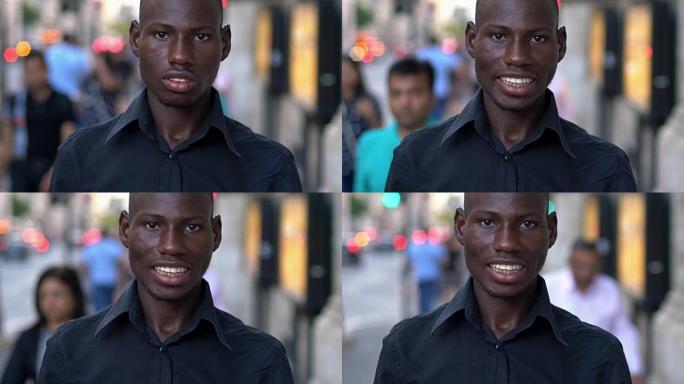 年轻的美国黑人男子在街上对着镜头微笑