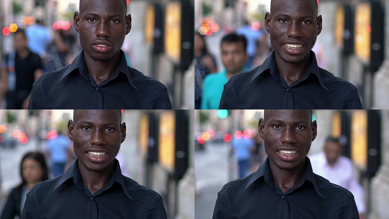 年轻的美国黑人男子在街上对着镜头微笑