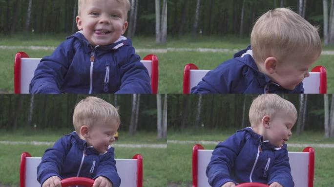 两岁快乐的男孩在玩具车秋千上玩耍。肖像。