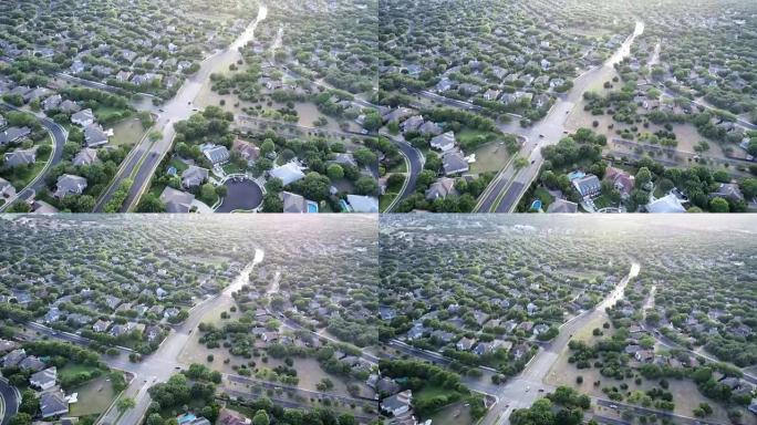 空中无人机的角度在多个郊区社区之间的交叉路口上方平移至日落