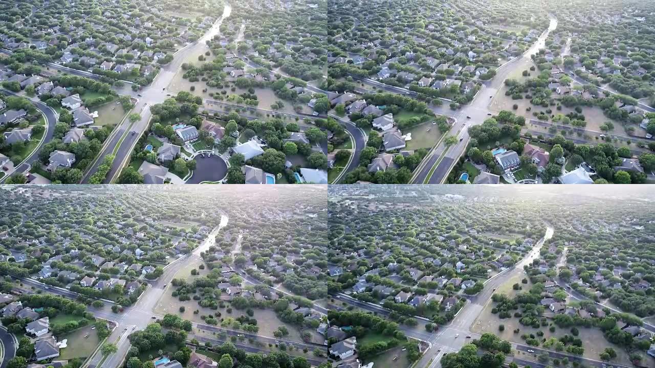 空中无人机的角度在多个郊区社区之间的交叉路口上方平移至日落