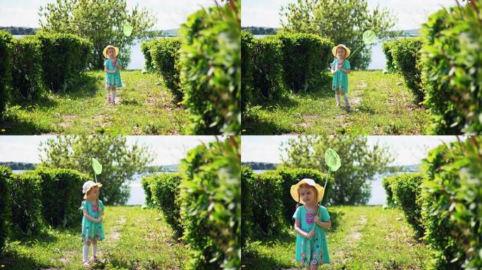 一个可爱的小女孩正在抓昆虫网。