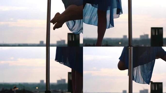 日落时表演钢管舞的年轻女子腿部剪影