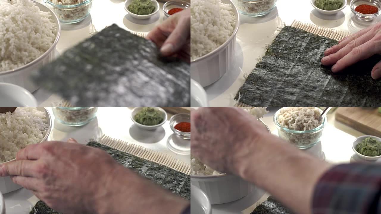 寿司厨师放下海藻纸和勺子一勺粘白米饭