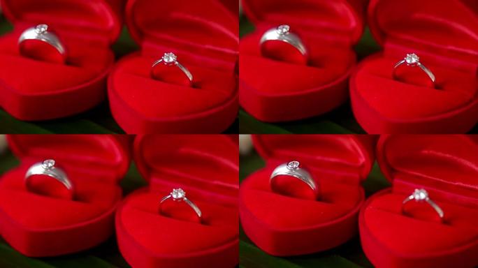 漂亮闪亮的结婚戒指，红色盒子，适合新娘和新郎。