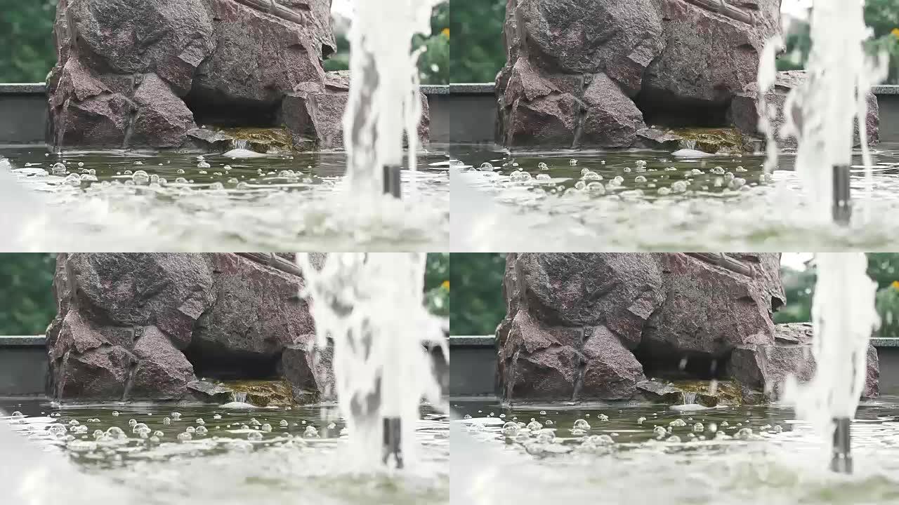 水流飞溅或喷出，喷泉飞溅。水压。夏日公园的喷泉。飞溅的溪流喷泉。强烈喷洒喷泉水，特写。