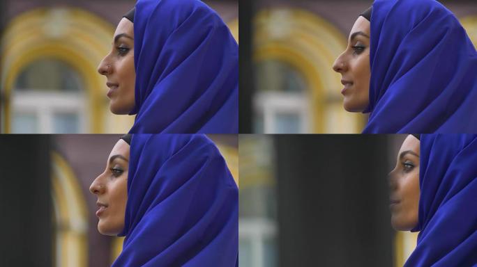 穿着蓝色头巾的年轻美丽穆斯林妇女的侧写