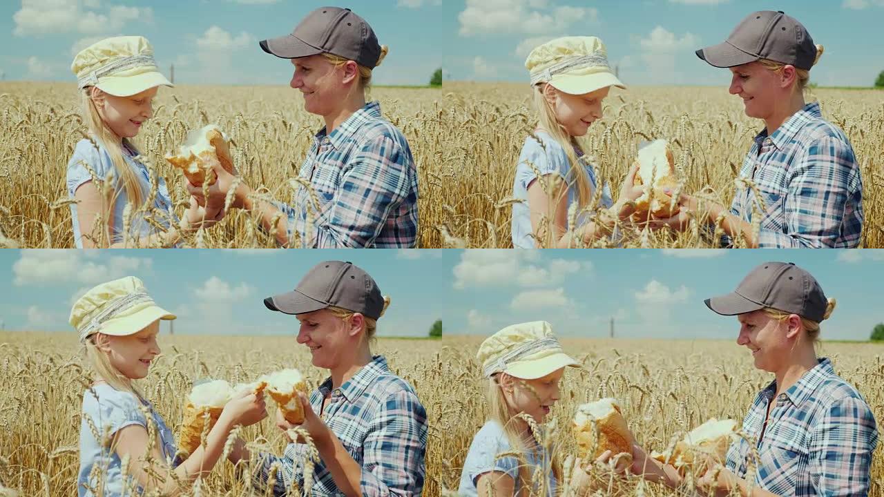 一个女农夫和一个女孩在麦田上打碎了一条面包。慷慨的复古概念