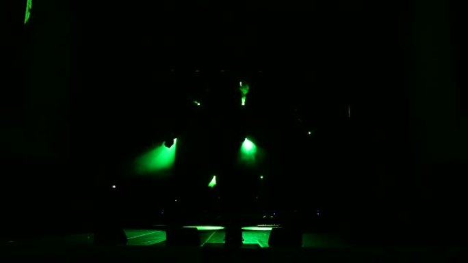 黑暗中空荡荡的音乐会舞台上的彩灯。