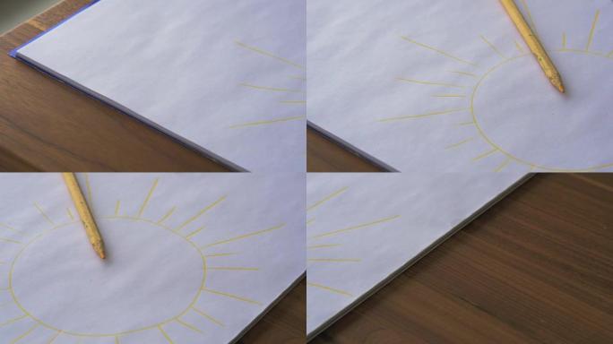 桌子表面的黄色彩色铅笔和黄色太阳素描