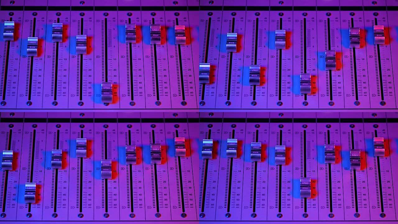 专业录音棚。声音处理设备的接口。推子。音频控制台的不同模式。创作歌曲或声音的过程。霓虹粉色旋钮灯
