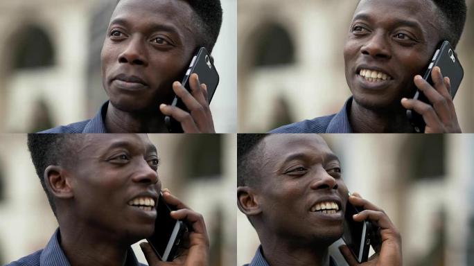 特写微笑的非洲男子通过电话交谈-户外