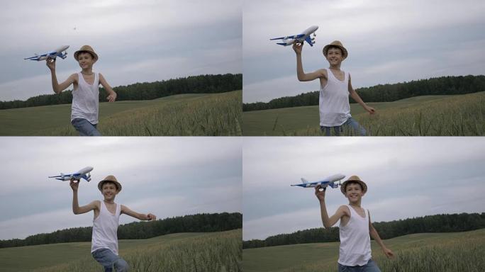 乡村男孩梦想家手里拿着一架飞机横穿田野