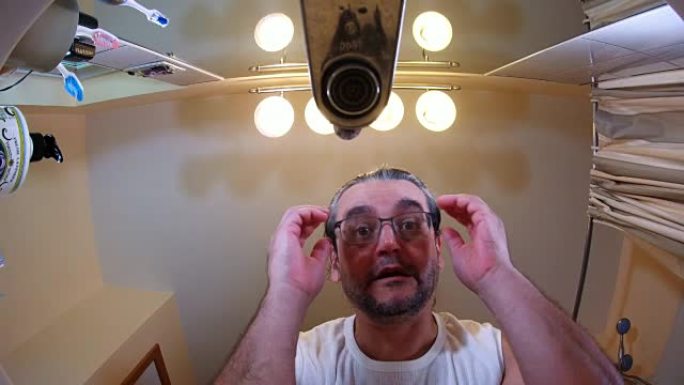 成熟的，45岁的，长发，不刮胡子的男人洗脸和洗手。