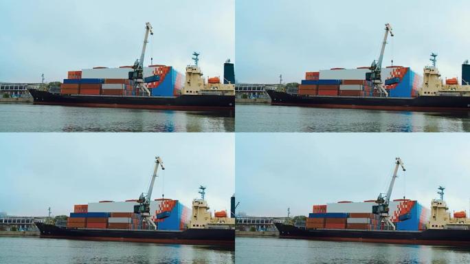 港口起重机从海上货船的甲板上卸下装有货物的集装箱