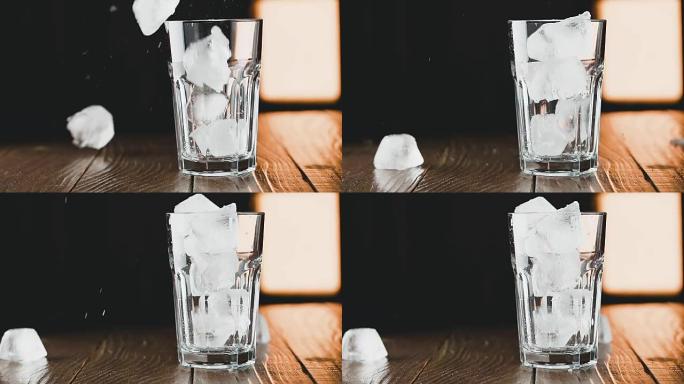 冰块落入玻璃杯中，慢动作。鸡尾酒概念。