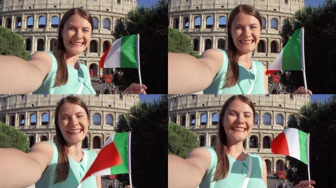 在意大利罗马罗马斗兽场附近自拍的女人。十几岁的女孩在慢动作中挥舞着意大利国旗