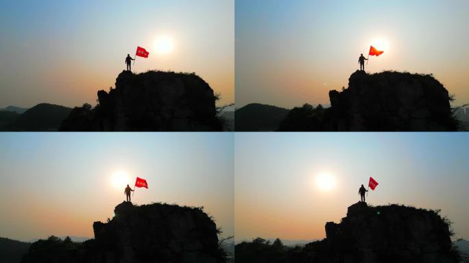 探险家登山成功山顶举起永不放弃的旗帜拼搏