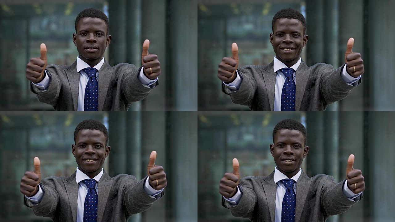 非洲黑人商人竖起两个大拇指。获胜，成功-户外