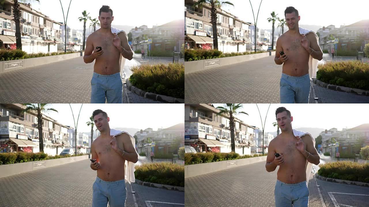旅行，快乐的裸身男人手拿手机在城市里行走