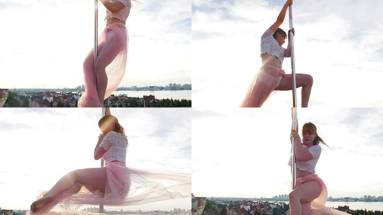 美丽的年轻女子钢管舞在背景城市景观的塔上旋转
