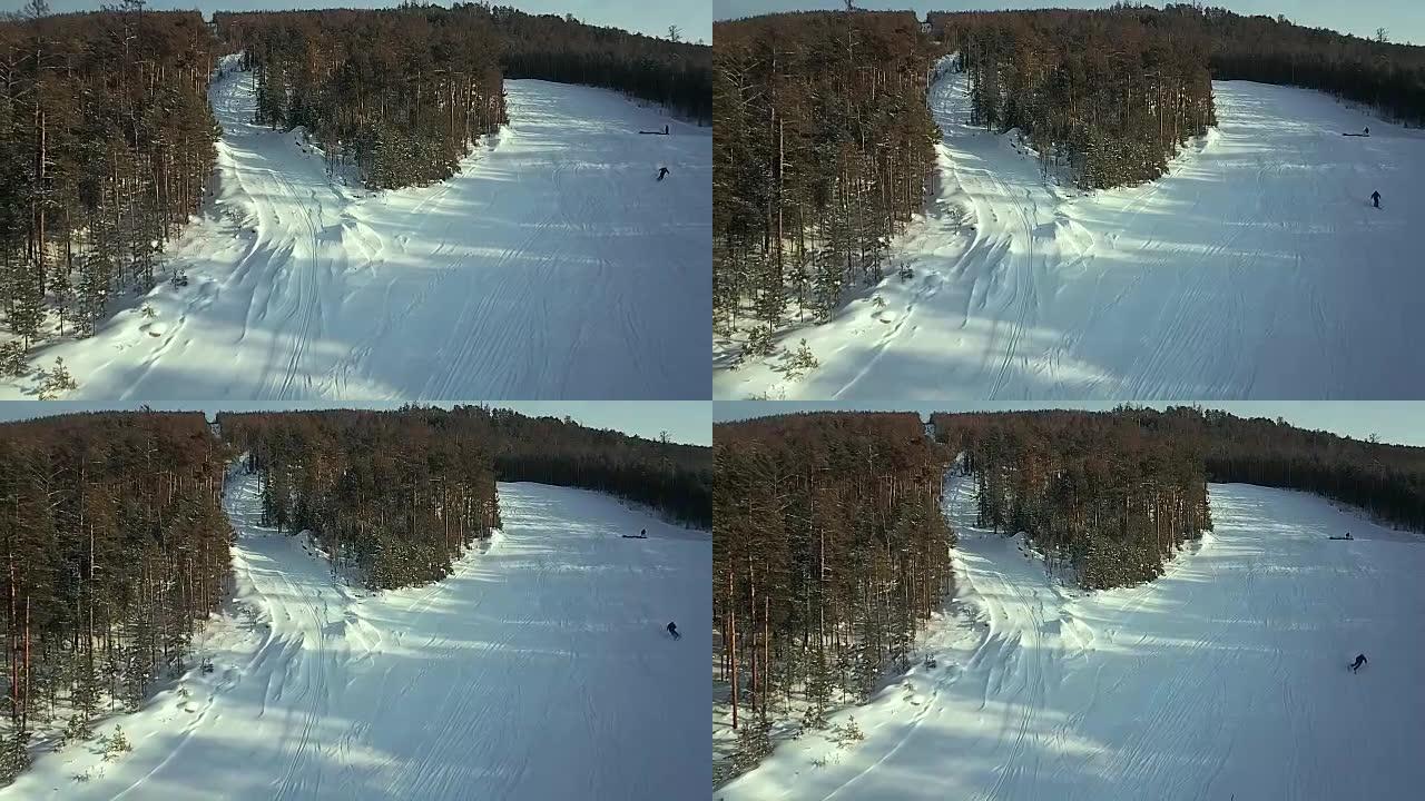 鸟瞰图: 滑雪者走下斜坡