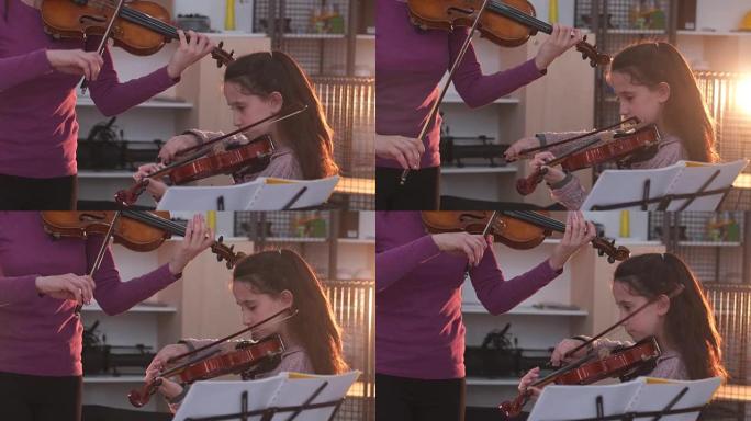 年轻女子教小女孩如何拉小提琴