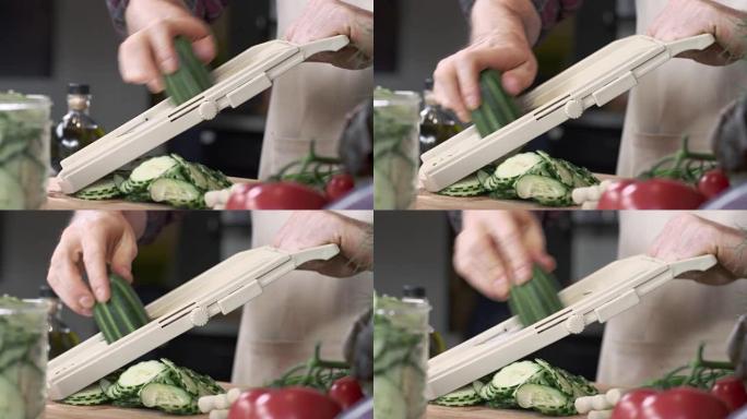 厨师用曼陀林切片新鲜黄瓜的跟踪镜头