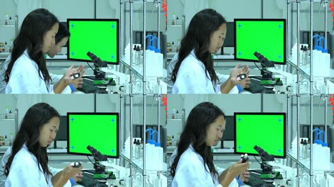 在现代实验室或医学中心工作的科学家。背景监视器绿色屏幕。科学、测试开发和实验室行业的概念。