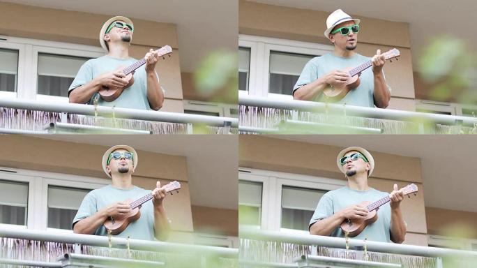 一位开朗的艺术家在夏天在阳台上演奏夏威夷四弦琴。