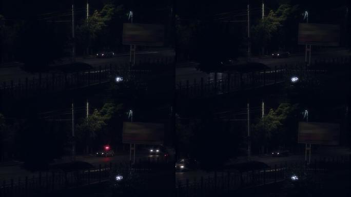 汽车在夜间道路上经过警车