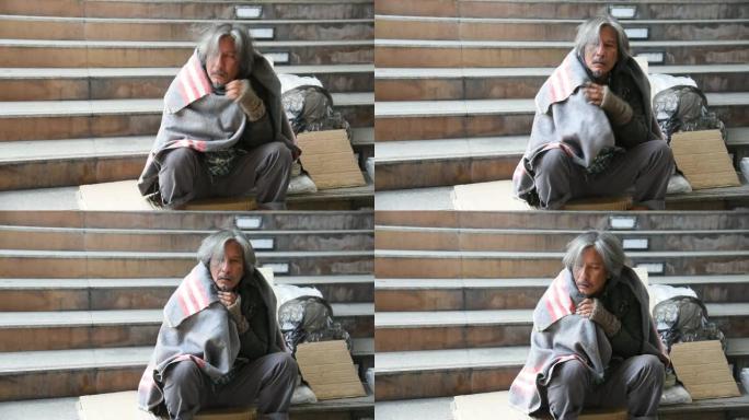 无家可归的人被覆盖在自己的毯子上，以防止寒冷的天气