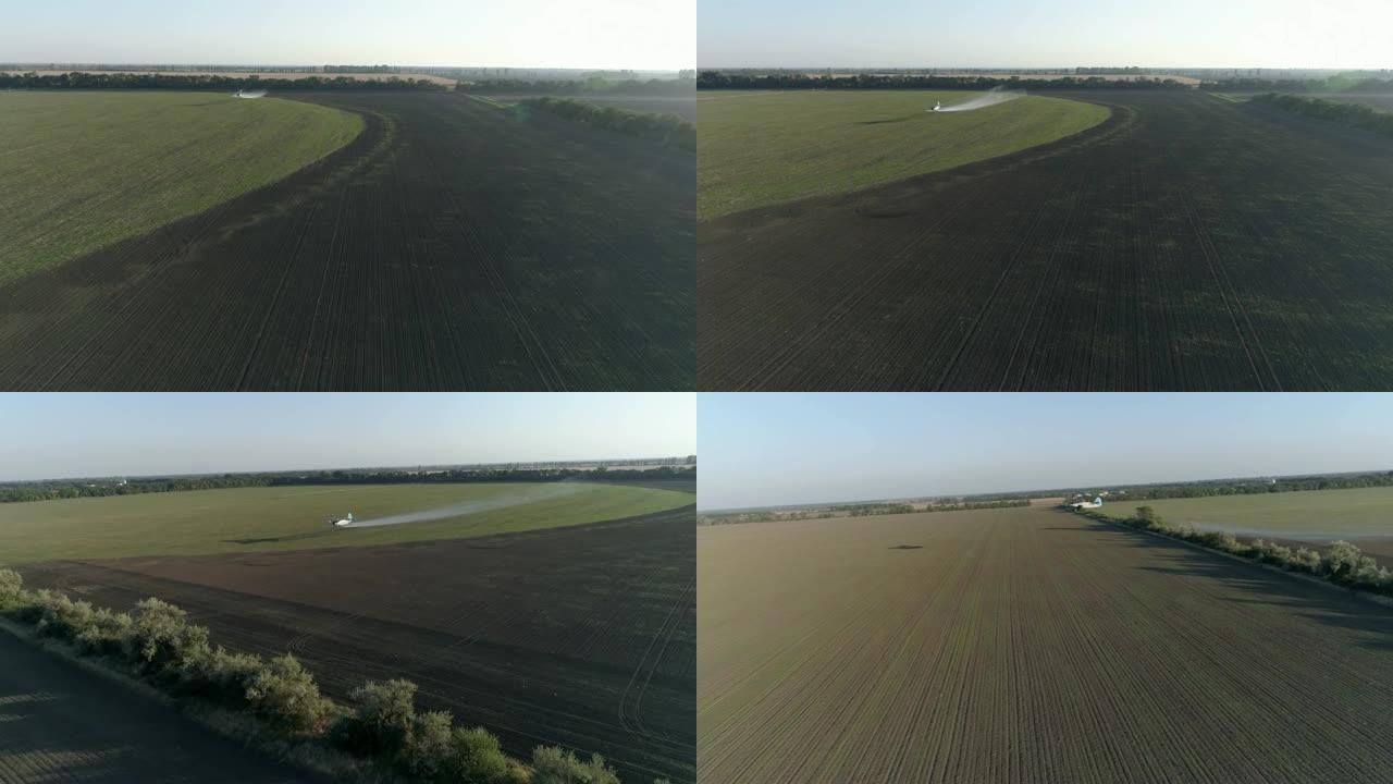 农业综合企业，飞机用小麦和喷洒除草剂对抗寄生虫，在老式推进飞机的航空调查中，飞机在种植园上空飞行得很