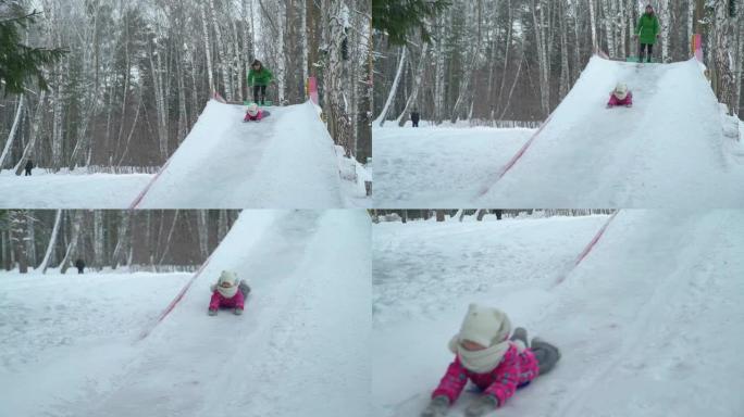 小女孩从大冰滑梯头朝下骑行