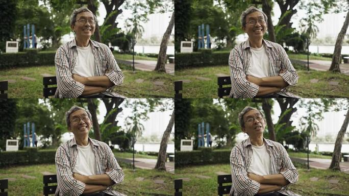 亚洲资深男子独自坐在公园微笑