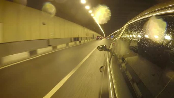 雨后汽车穿过隧道。车身侧视图