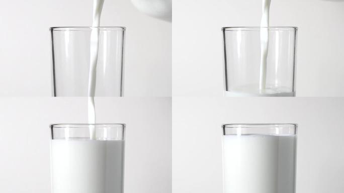 特写从白色背景的水罐中倒出新鲜牛奶