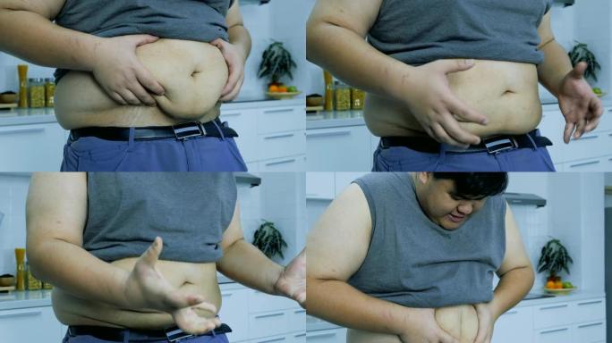触摸并检查胖子的大肚子。当今社会的概念保健和肥胖