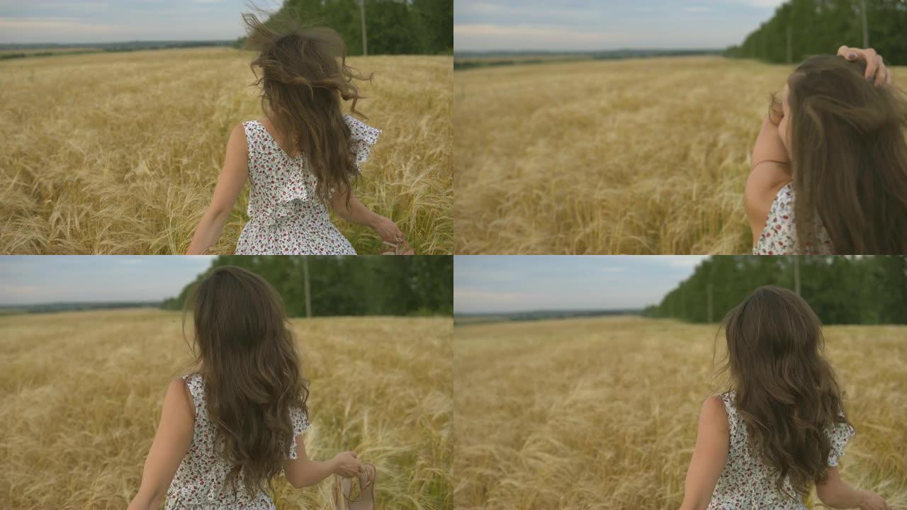 穿着裙子在野外奔跑的年轻漂亮女人。金色草地上微笑的女孩。