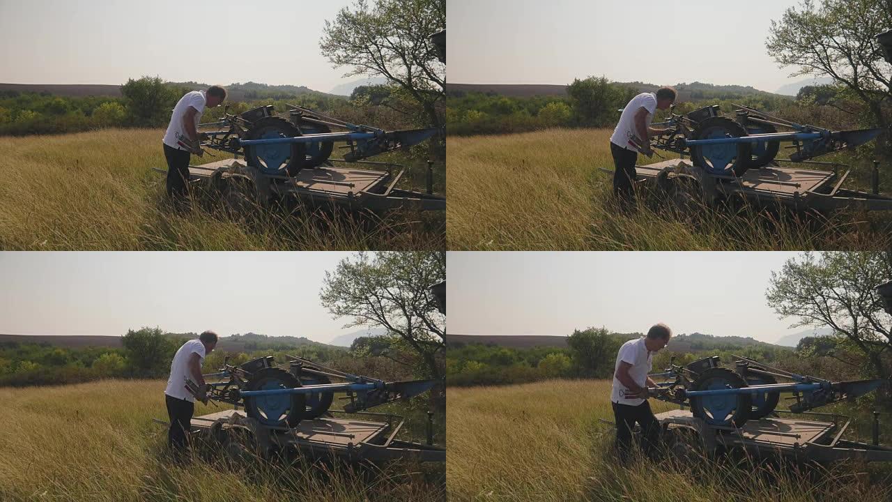 一名男子检查的汽车拖车上的割草机