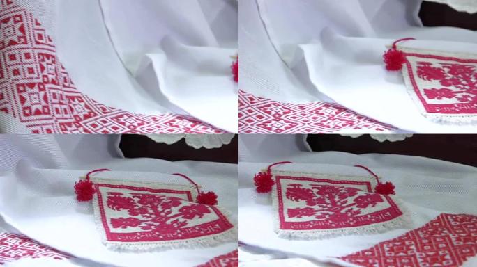 民族红白刺绣。装饰毛巾装饰的过程绣花红色装饰品。