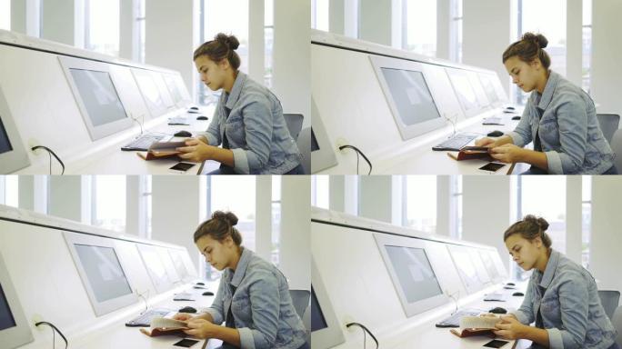在电脑附近学习的年轻女子