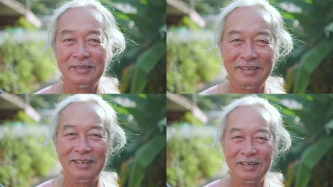 60年代男子肖像，亚洲高级男子微笑。老年人看着相机。