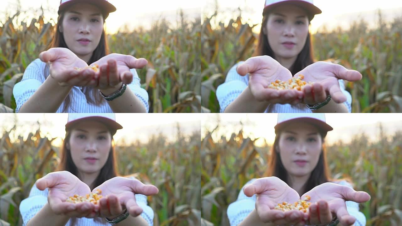 亚洲年轻女农民倒玉米